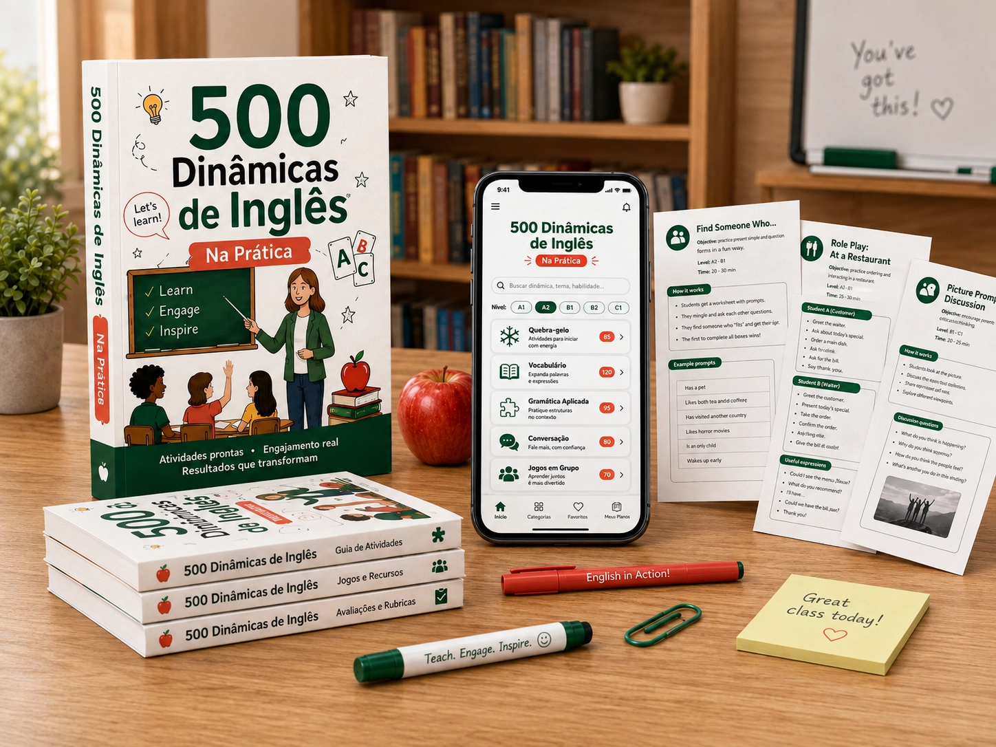 Mockup do app 500 Dinâmicas de Inglês Na Prática, com livro, celular e folhas de atividade